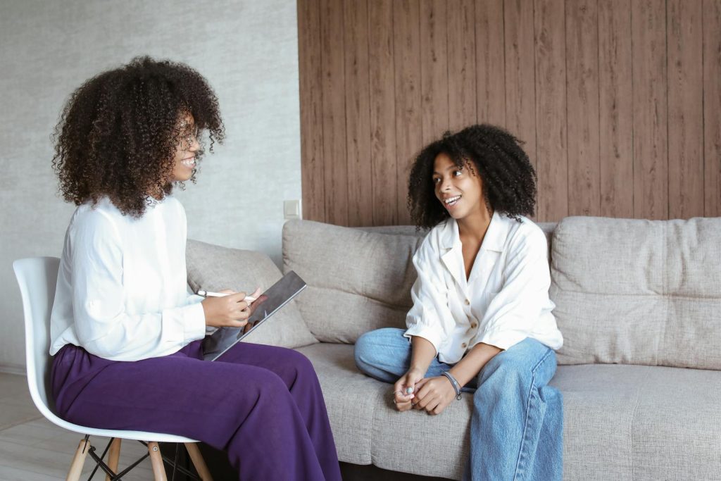 Women Having Conversation while Looking at Each Other